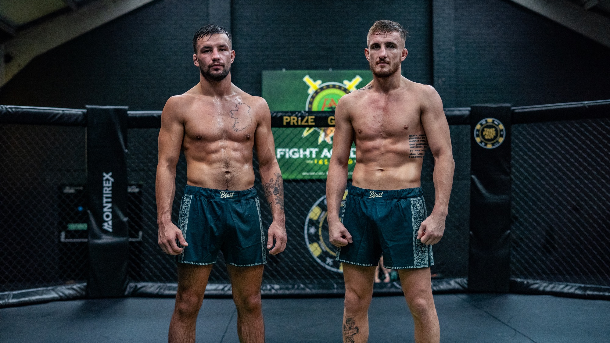 Two fighters in green BFAST Emerald Fight Shorts standing in a cage